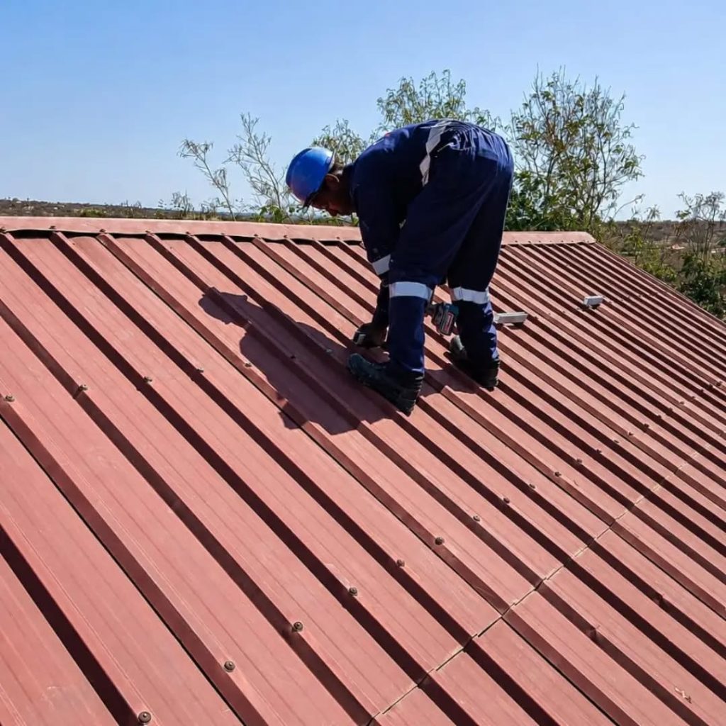 Delta Power Links technician fitting solar panel mounts on Madam Diana’s roof