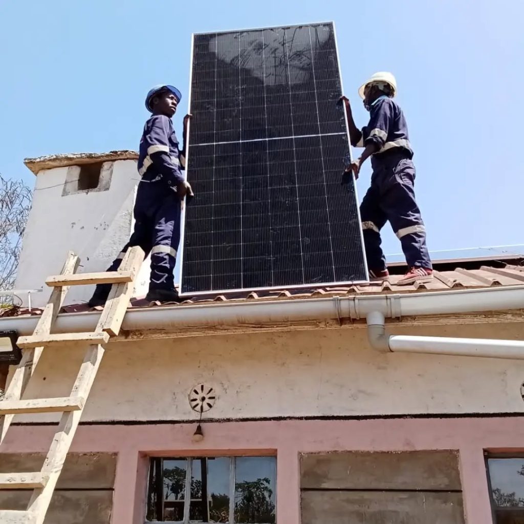 Solar panel being lifted into position on Madam Diana’s roof