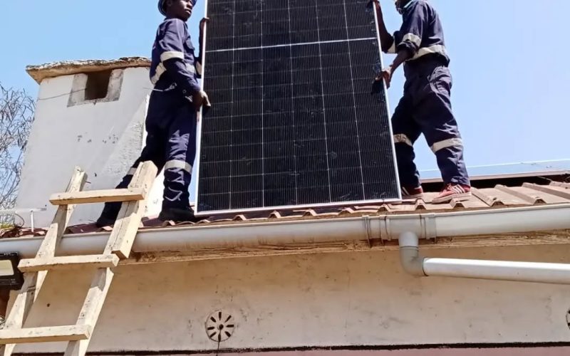 Solar panel being lifted into position on Madam Diana’s roof